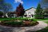 Charming apartment building surrounded by lush greenery and a beautifully landscaped garden, perfect for tranquil living.