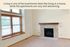 Cozy living room with a stylish stone fireplace and large window, offering a warm and inviting ambiance.