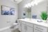 Sleek bathroom with modern fixtures, stylish vanity, and artistic decor.