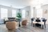 Bright and modern living space with a comfortable sofa, stylish armchairs, and elegant dining area.