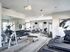 Well-equipped fitness center with modern exercise machines, free weights, and stationary bikes.