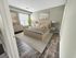 Chic bedroom with a plush bed, modern decor, and large window providing natural light.