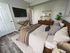 Chic bedroom view with modern furnishings, wooden bed, and stylish decor.