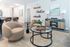 Modern living room with stylish furniture, glass coffee table, and elegant decor.