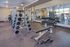 Modern gym facility with dumbbells, weight machines, and spacious layout.