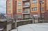 Urban apartment building with stylish grill area, highlighting outdoor living space.