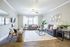 Stylish living room with modern gray sofas, chic decor, and natural lighting.