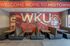 Dynamic wall mural in a welcoming dining area with booths and sports-themed artwork.