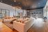 Chic living space featuring modern sofas, stylish light fixtures, and a billiards table.