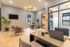 Modern and stylish office space with wooden flooring, sleek furniture, and ample natural light.