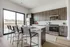 Bright and inviting kitchen with modern appliances, sleek cabinetry, and a spacious island with seating.