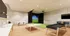 Elegant recreational space featuring a golf simulator, table tennis, and lounge area with modern amenities.