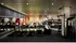 Modern gym with advanced treadmills, weight racks, and exercise equipment set against a stylish backdrop.