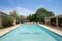 Inviting outdoor pool area with lounge chairs and greenery at Oxford West.