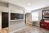Stylish interior featuring a secure package locker system and a cozy seating area with vibrant red accents.