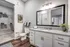 Elegant bathroom featuring a spacious granite countertop, modern fixtures, and a walk-in closet with ample storage space.