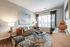 Inviting living room with a modern sofa, elegant coffee table, and large window allowing abundant natural light.