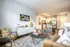 Chic open-concept living room and kitchen with elegant decor, modern furniture, and warm lighting creating a cozy yet stylish atmosphere.