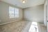 Bright and spacious bedroom with plush carpeting and expansive window views, exuding warmth and inviting natural light.