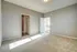 Bright, spacious room with plush carpeting, large closet, and easy access to a luminous bathroom, ideal for modern living.