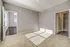 Bright, sunlit bedroom with plush carpeting and access to an elegant walk-in closet.