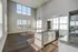 Bright and airy open-concept kitchen with high ceilings, granite countertops, and large windows offering abundant natural light.