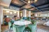 Luxurious community lounge featuring elegant decor, plush velvet seating, a sleek marble table, and modern workspace, perfect for relaxation and productivity.