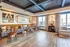 Elegant dining area with plush seating, stylish wooden chairs, and large windows offering natural light.
