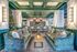 Elegant living area with plush green sofas, artistic lighting, and festive decor, perfect for entertaining and relaxation.