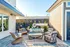 Inviting patio space with modern wicker furniture and stylish decor, perfect for relaxation and outdoor entertainment.