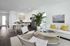 Modern open-plan living room and kitchen with stylish decor, featuring a cozy sofa, vibrant plant, and contemporary dining area.
