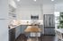 Contemporary kitchen with stainless steel appliances, sleek white cabinets, and a stylish wooden island centerpiece.