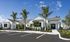 Charming modern apartments with lush palm-lined landscaping and ample parking in a serene setting.