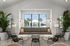Inviting modern lounge area with elegant seating, stylish decor, and a panoramic view of a sparkling outdoor pool through large windows.