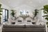 Elegant lounge area with modern seating, lush greenery, and abundant natural light creating a serene ambiance.