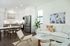 Bright modern living space featuring sleek kitchen with stainless steel appliances, cozy dining area, and stylish lounge with elegant decor.