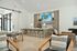 Chic modern living space with open kitchen, sleek bar seating, and cozy dining area, perfect for entertaining.