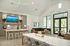 Elegant open-concept living area with large windows, modern kitchen, and stylish dining space offering a bright, airy ambiance.