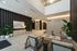 Modern apartment lobby featuring elegant seating, lush green plants, and stylish wall art.
