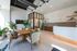 Modern and inviting communal space at '80 On The Commons' featuring sleek furniture, abundant natural light, and lush green plants creating a welcoming atmosphere.