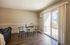 Inviting living area with modern table setting, elegant sliding glass doors, and warm natural light.