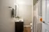 Modern bathroom with elegant design featuring a sleek vanity, spacious mirror, and stylish geometric shower curtain.