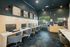 Modern co-working space with sleek workstations, ergonomic chairs, and ambient lighting, perfect for productivity and collaboration.