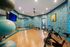 Inviting and vibrant fitness room with exercise bikes, yoga balls, and a mirrored wall, perfect for energizing workouts in a modern setting.