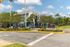 Inviting entrance to The Verge Orlando with palm trees, lush landscaping, and welcoming signage.