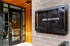 Inviting entrance of The Sutton showcasing elegant wood detailing and modern signage.