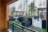 Chic urban outdoor patio with stylish seating, lush greenery, and elegant pergolas for a serene living experience.