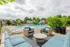 Inviting outdoor pool area with elegant lounge chairs, cozy seating, and lush greenery, perfect for relaxation.