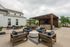 Inviting outdoor patio with modern seating, shaded pergola, and lush landscaping perfect for relaxation and social gatherings.