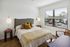 Bright and inviting bedroom with stylish decor, large window view, and modern furnishings for a cozy ambiance.